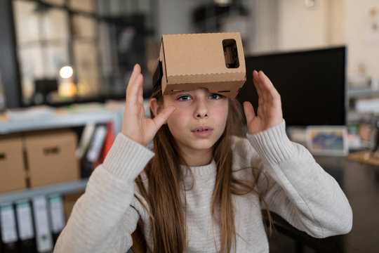 Girl With Cardboard VR Glasses In Office