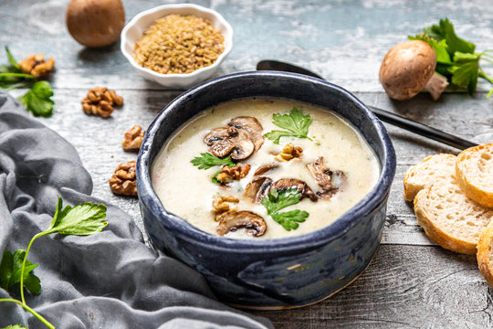Bowl of German spelt soup with mushrooms, walnuts and parsley