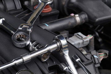 Obraz premium Car repair workshop. Wrenches for repair lying in the engine compartment.