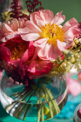 Flowers as a decoration at a wedding. Stunningly beautiful pink peonies in a glass vase.