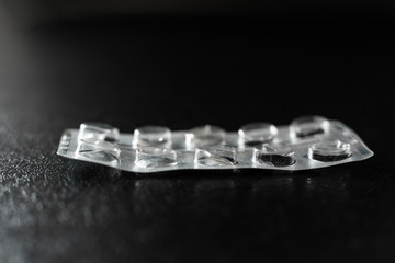 Empty blister from pills lies on the table