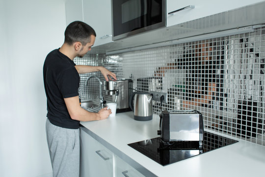 Guy prepare delicious aromatic coffee in a coffee machine. A simple way to make coffee
