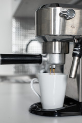 Close-up of making coffee in a coffee machine.