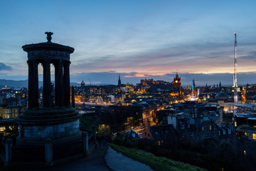 Sunset from Calton Hill in Edinburgh with panoramic view of the castle and Christmas market