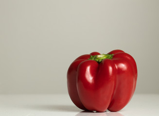 Fresh red bell pepper sitting on table