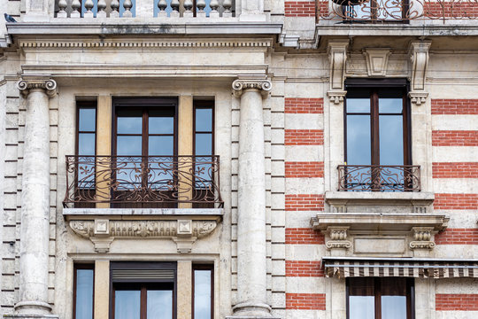 Facade of a historic brick building with metal balconies. Geneva, Switzerland