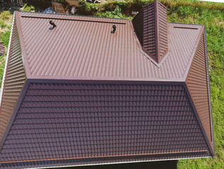 A view from above on the roof of the house. The roof of corrugated sheet. Roofing of metal profile wavy shape