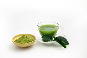 Hot fresh Green Tea drink in through white glass cup and dish. Place with deep green tea leaves and extract powder in wooden bowl on white Background.