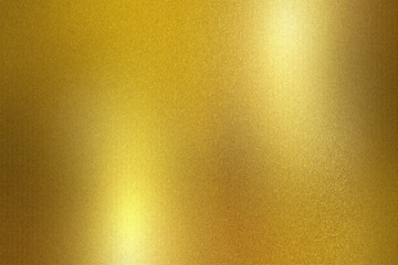 Gold foil metallic wall with glowing shiny light, abstract texture background