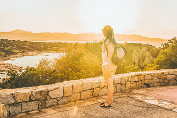Girl looking at Capo Ferro in the Mediterranean Sea in Costa Smeralda in Sardinia in Italy