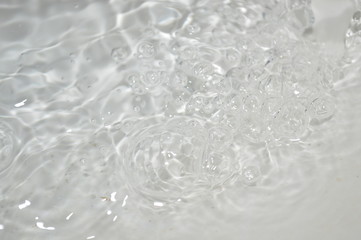 The surface of the water in a white container