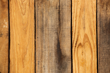 Rough Cut Pallet Wood Background. THis backdrop features prominant dark verticles stripes between bands of brown, golden, and gray wooden planks.