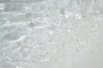 The surface of the water in a white container