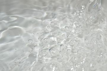 The surface of the water in a white container