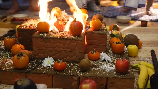 Group of Hindu practitioners performing homa fire ritual during the ceremony of prana pratishta