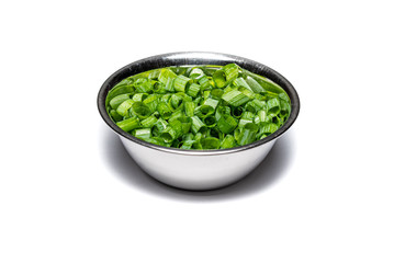 Chopped Chive garnish isolated on a white background, prepared herbs in a silver dish.