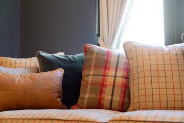 close up of soft fabric pillow decoration on beautiful sofa in living room home design concept