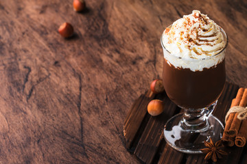 Hot chocolate with whipped cream and cocoa powder. Winter and autumn time. Christmas warm drink. Copy space