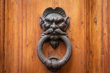 Devil cast iron door knocker in Florence, Italy