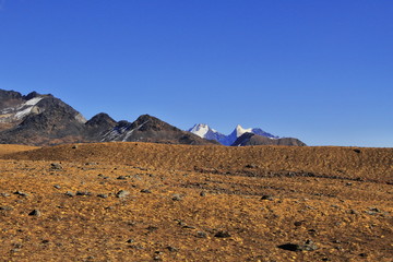 arid landscape of tibetan plateau and snow-capped himalaya at bum la pass near tawang in arunachal pradesh, india
