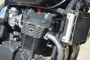 Four cylinder four carburettor four stroke motor bike inline engine with cooling fins and cooling...