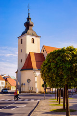 Main Liberty square with crossroads at Our Lady of the Seven Sorrows Church in Old center in Slovenska Bistrica near Maribor in Slovenia. City in South Styria in Slovenija. Bell tower of Cathedral