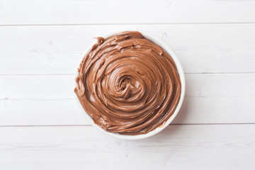 Nougat nut chocolate in a plate on a white background. Selective focus.