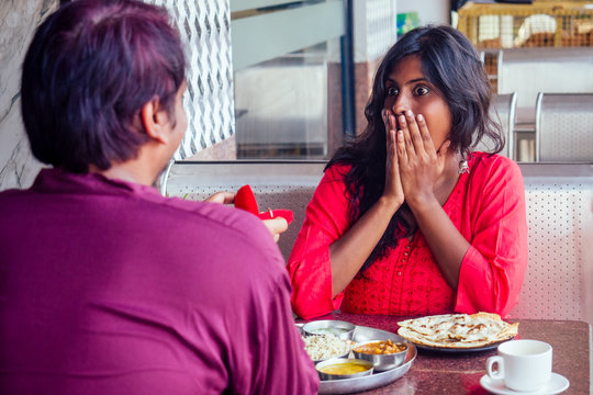 amased and surprised indian woman feeling happy to get proposal from her boyfriend in restaurant. i said yes