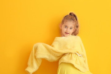 Cute fashionable girl on color background