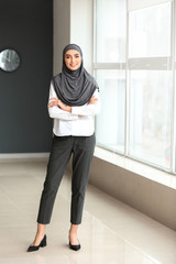 Fototapeta na wymiar Beautiful Arab businesswoman near window in office