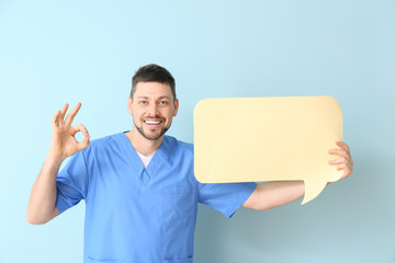Man with blank speech bubble showing OK on color background