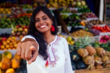 smiling indonesian business woman in kerala goa sell fruit and vegetable farm