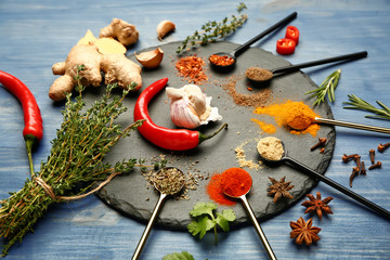 Many different spices on wooden background