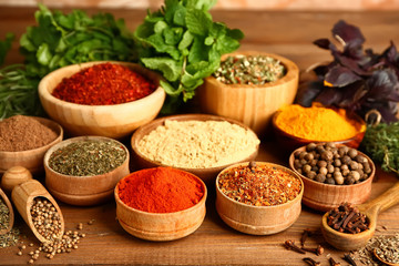 Composition with different spices on wooden background