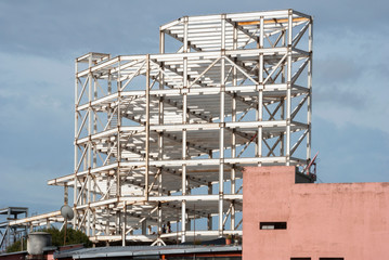 Fototapeta na wymiar Metal structure for the construction of modern building in Guatemala City, civil engineering and urban architecture, integration of spaces in Latin American city.