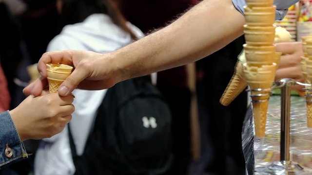 Close up view of turkish dondurma seller making classic fun tricks with customer
