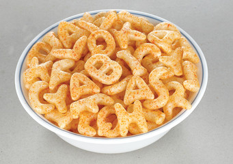 Fried and Spicy ABCD, Alphabet Snacks or Fryums (Snacks Pellets) served in a white bowl. selective focus - Image