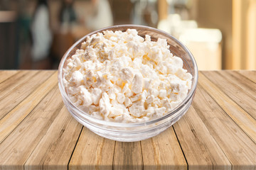 Desi Makhan, Fresh cottage cheese in a bowl with spoon & buttermilk on a white background. - image.
