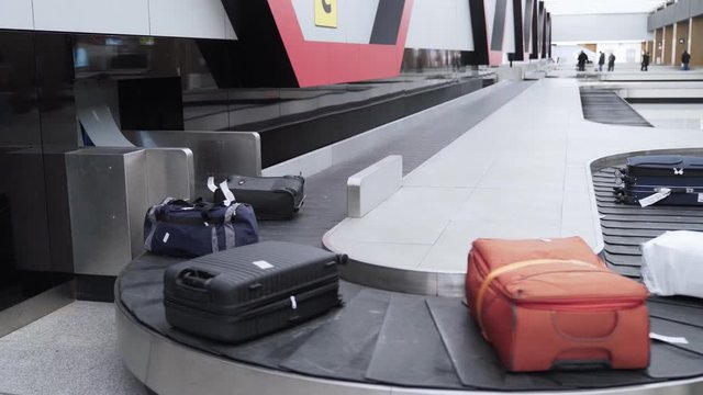 Luggage on a conveyor belt in the baggage claim area of international airport