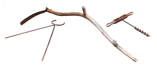 Old-fashioned rusty and well-used tools and farm equipment isolated on a white background