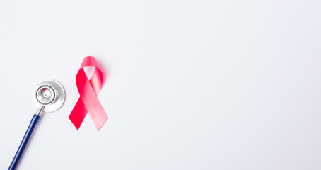 Breast cancer month concept, flat lay top view, pink ribbon and stethoscope