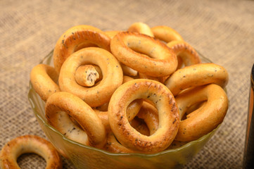 Small bagels on a background of rough homespun fabric close-up.