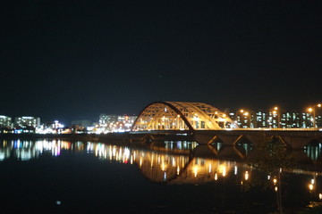 Night view of a beautiful scene of bridge over sea water in the evening time.