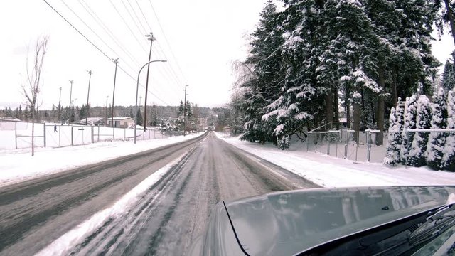 Driving Perspective on Ice in Snow Covered Residential Neighborhood