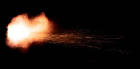 the texture of a shot from a firearm on a black background, the output of gunpowder gases from the barrel of a rifle and a pistol