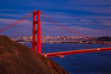 Fototapeta na wymiar View of the Golden Gate bridge with the Marin Headlands and San Francisco skyline at colorful sunset, California