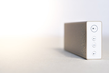 Closeup & Selective focus, Control buttons of modern and beautiful gold aluminium bluetooth speaker...