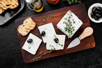 Sliced Feta cheese with herbs and olive oil.