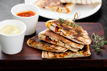 Mexican quesadilla with chicken meat,sweetcorn and pepper served with different sauces.