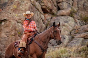 Fototapeta premium Cowgirl Riding on Rocks